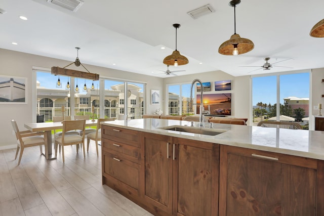 kitchen with a sink, ceiling fan, plenty of natural light, and recessed lighting