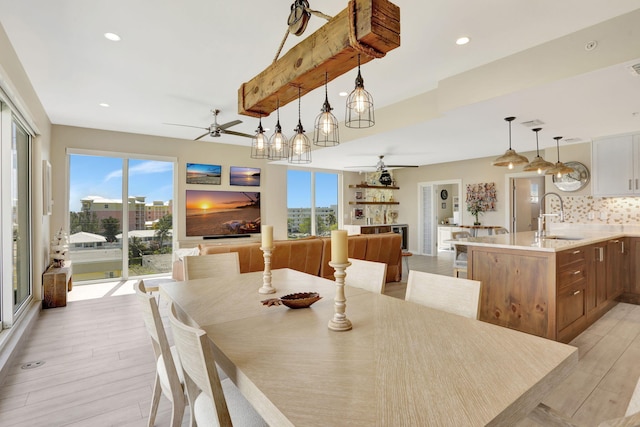 dining area with a ceiling fan, light wood finished floors, plenty of natural light, and recessed lighting