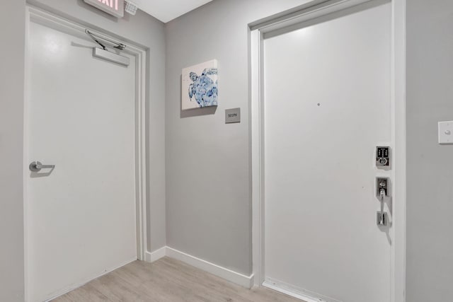 entryway featuring light wood-style flooring and baseboards