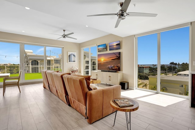 living area with ceiling fan, light wood-style floors, and recessed lighting