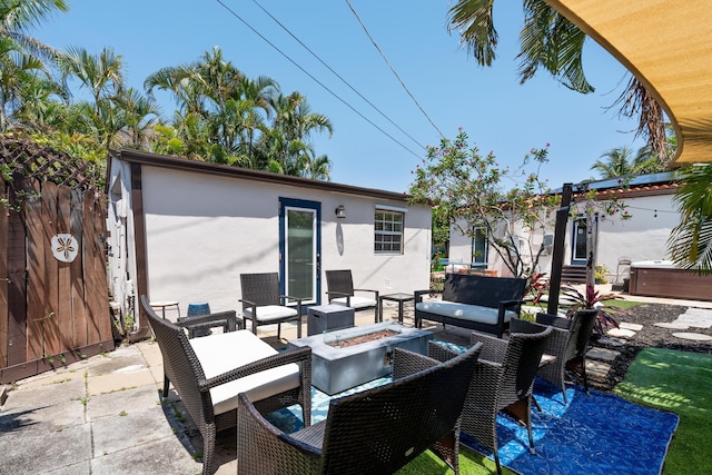 view of patio / terrace featuring an outdoor living space with a fire pit, fence, and entry steps