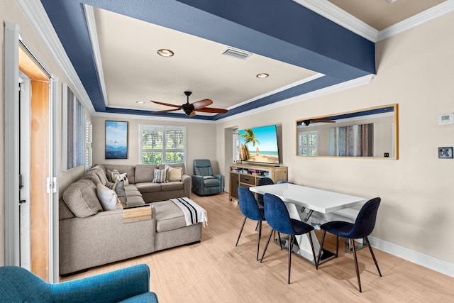 dining room with ornamental molding, a raised ceiling, wood finished floors, ceiling fan, and recessed lighting