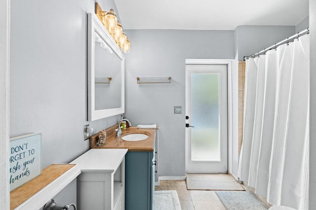 full bathroom featuring vanity and baseboards