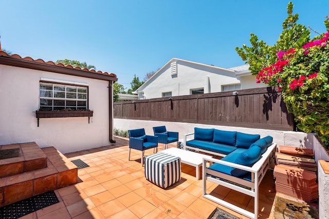 view of patio / terrace featuring an outdoor hangout area and fence