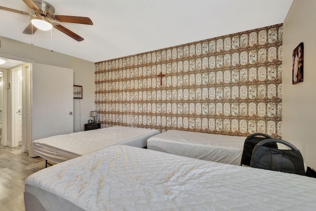 bedroom featuring wood finished floors and ceiling fan