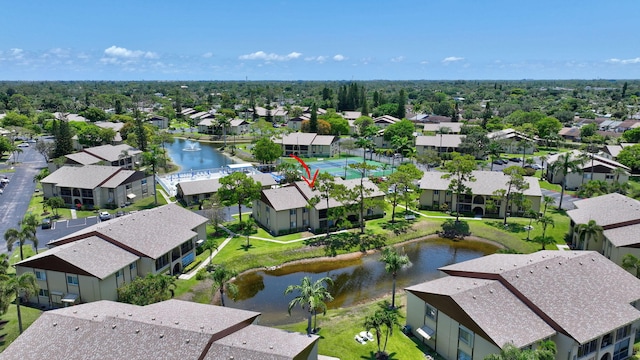 aerial view of residential area featuring a large body of water