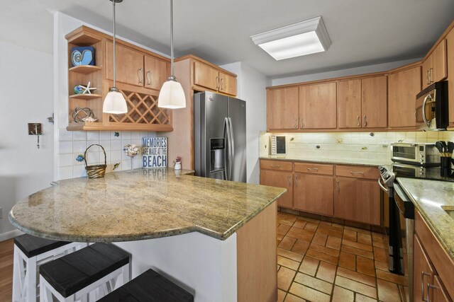 kitchen with appliances with stainless steel finishes, a peninsula, open shelves, and tasteful backsplash