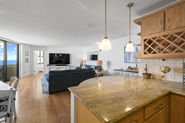 kitchen featuring tasteful backsplash, brown cabinets, and light wood-style flooring