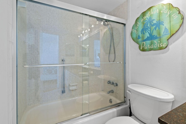 bathroom featuring enclosed tub / shower combo and toilet