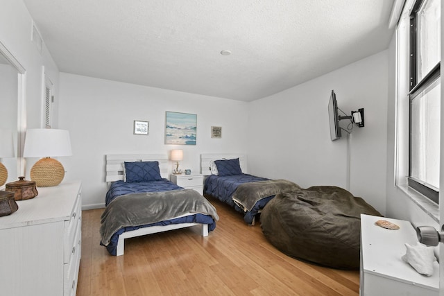 bedroom featuring light wood-style flooring