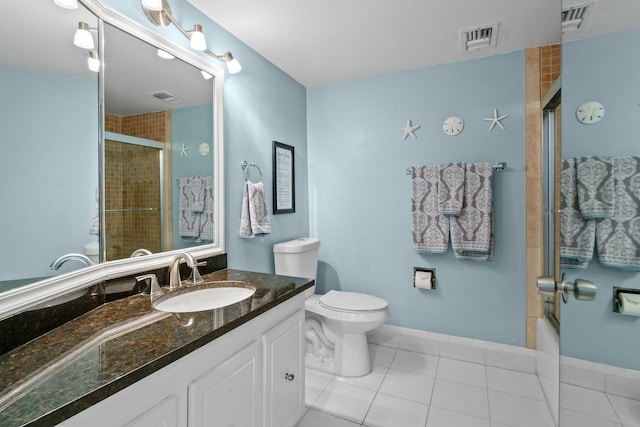 bathroom with toilet, tile patterned flooring, vanity, and baseboards