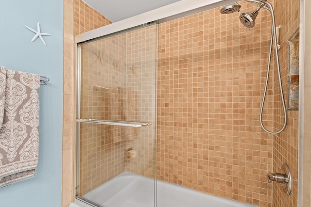 bathroom featuring shower / bath combination with glass door