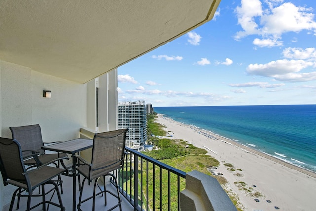 balcony with view of water and beach