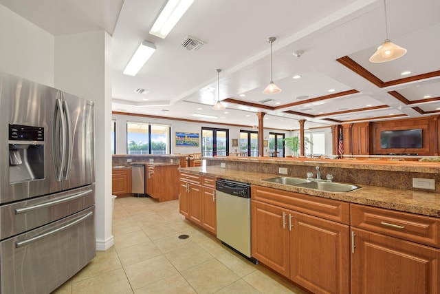 kitchen with stainless steel appliances, a sink, light tile patterned floors, beam ceiling, and brown cabinets