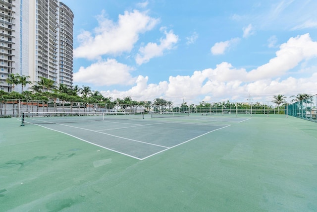 view of tennis court featuring fence