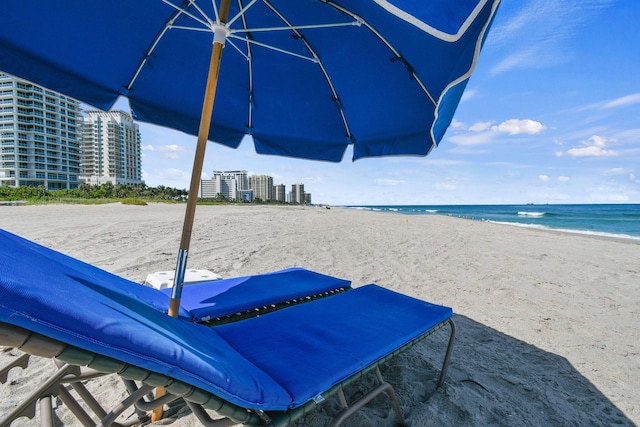 surrounding community with view of water and beach