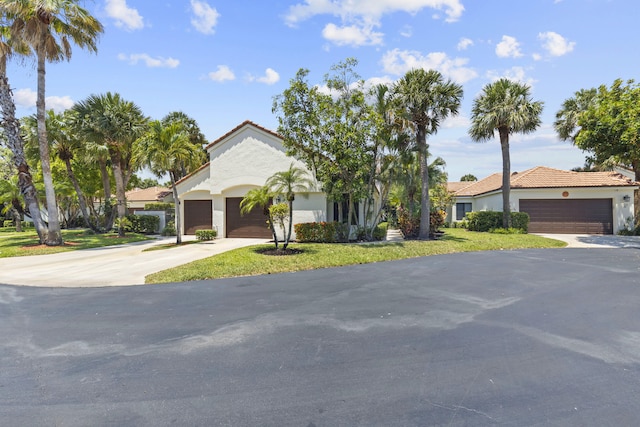 701 Sea Oats Dr Unit A-4, Juno Beach, FL 33408 - mediterranean / spanish-style house with concrete driveway, a tiled roof, and an attached garage