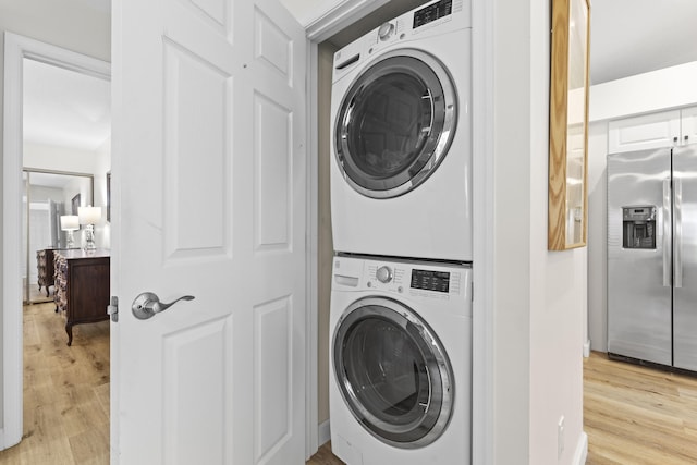 701 Sea Oats Dr Unit A-4, Juno Beach, FL 33408 - laundry area with stacked washer and clothes dryer and light wood-type flooring