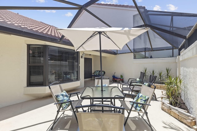 701 Sea Oats Dr Unit A-4, Juno Beach, FL 33408 - view of patio / terrace with glass enclosure and outdoor dining space