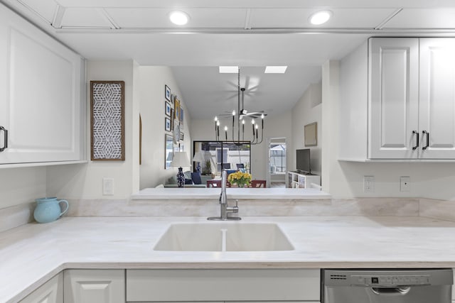 701 Sea Oats Dr Unit A-4, Juno Beach, FL 33408 - kitchen with stainless steel dishwasher, light countertops, white cabinetry, recessed lighting, and a chandelier