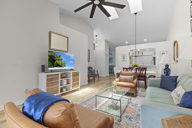 701 Sea Oats Dr Unit A-4, Juno Beach, FL 33408 - living area with a ceiling fan, lofted ceiling, light wood-type flooring, a skylight, and a chandelier