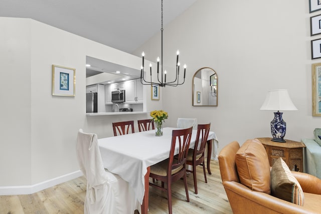 701 Sea Oats Dr Unit A-4, Juno Beach, FL 33408 - dining space featuring light wood finished floors, a chandelier, and high vaulted ceiling