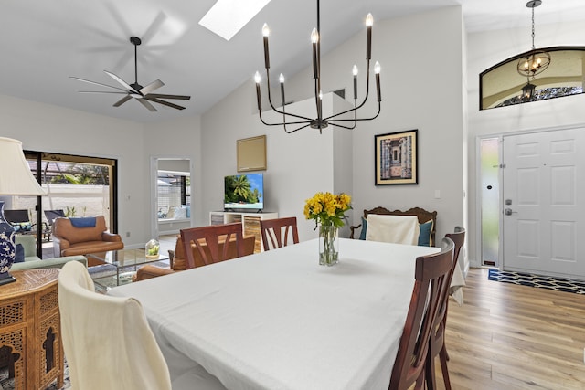 701 Sea Oats Dr Unit A-4, Juno Beach, FL 33408 - dining space with a chandelier, high vaulted ceiling, light wood finished floors, a skylight, and a ceiling fan