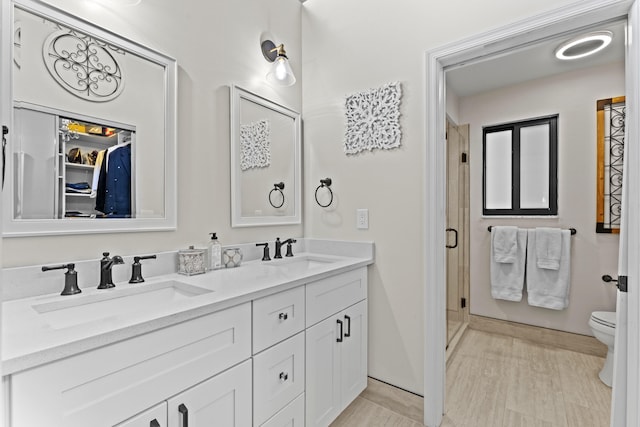701 Sea Oats Dr Unit A-4, Juno Beach, FL 33408 - bathroom with double vanity, a stall shower, and a spacious closet