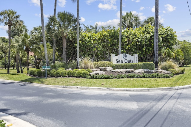 701 Sea Oats Dr Unit A-4, Juno Beach, FL 33408 - community sign with a lawn and view of wooded area