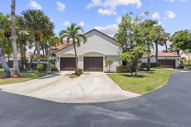 701 Sea Oats Dr Unit A-4, Juno Beach, FL 33408 - mediterranean / spanish-style house with a front lawn, stucco siding, and concrete driveway