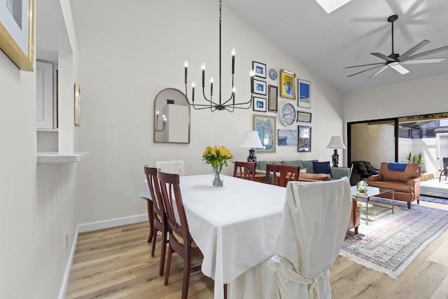 701 Sea Oats Dr Unit A-4, Juno Beach, FL 33408 - dining room with light wood-style flooring, a ceiling fan, and a chandelier