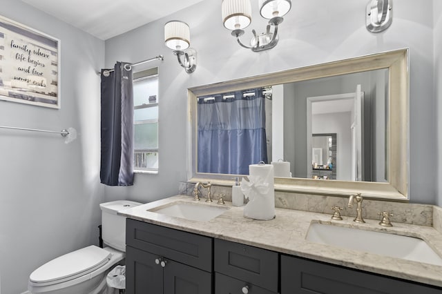 8611 NW 47th Ct, Lauderhill, FL 33319 - full bathroom featuring double vanity, toilet, and a chandelier