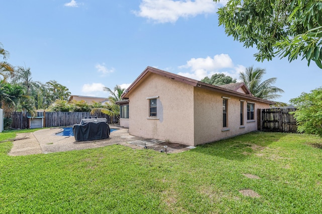 8611 NW 47th Ct, Lauderhill, FL 33319 - rear view of property with stucco siding and a patio area