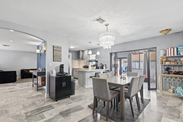 8611 NW 47th Ct, Lauderhill, FL 33319 - dining room with arched walkways and a chandelier