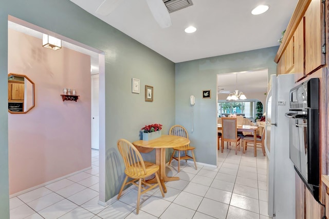dining space with light tile patterned floors, a chandelier, baseboards, and recessed lighting
