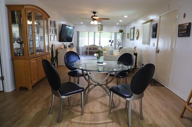 521 Sandpiper Cir, Delray Beach, FL 33445 - dining space featuring a ceiling fan, light wood finished floors, and baseboards