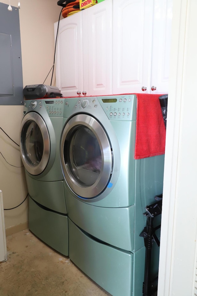 521 Sandpiper Cir, Delray Beach, FL 33445 - laundry room with washing machine and dryer, electric panel, and cabinet space