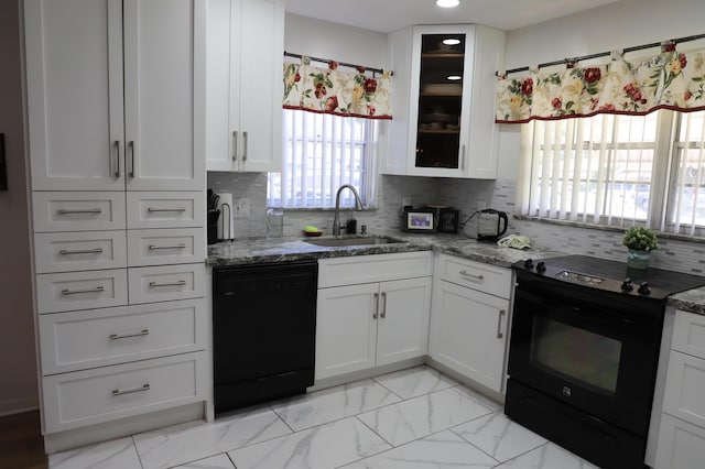 521 Sandpiper Cir, Delray Beach, FL 33445 - kitchen with black appliances, a sink, white cabinets, stone counters, and glass insert cabinets