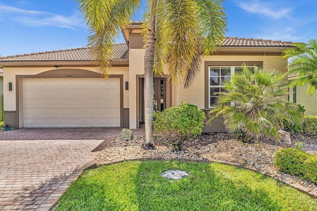 14838 Strand Ln, Delray Beach, FL 33446 - view of front facade with stucco siding, a tile roof, and decorative driveway