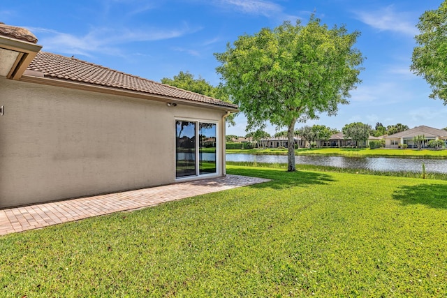 14838 Strand Ln, Delray Beach, FL 33446 - view of green lawn featuring a water view and a patio