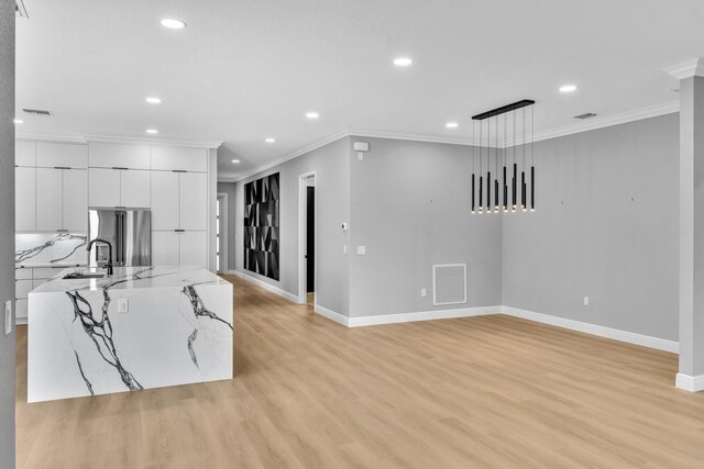 14838 Strand Ln, Delray Beach, FL 33446 - kitchen with stainless steel fridge, recessed lighting, baseboards, light wood-style floors, and ornamental molding