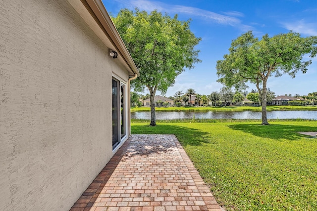 14838 Strand Ln, Delray Beach, FL 33446 - view of grassy yard featuring a water view, a patio, and a residential view