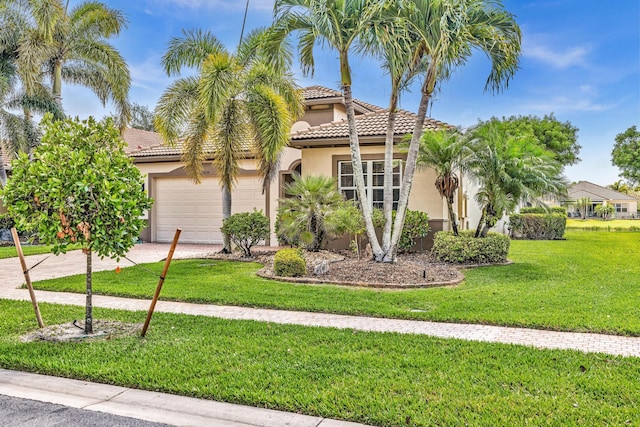 14838 Strand Ln, Delray Beach, FL 33446 - mediterranean / spanish-style home featuring stucco siding, a garage, a tiled roof, a front yard, and driveway
