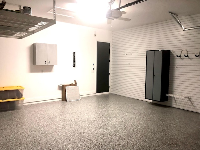 14838 Strand Ln, Delray Beach, FL 33446 - garage with a garage door opener, ceiling fan, and baseboards