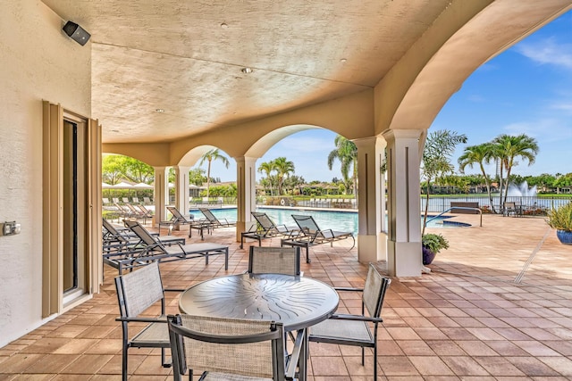 14838 Strand Ln, Delray Beach, FL 33446 - view of patio featuring a community pool and a water view