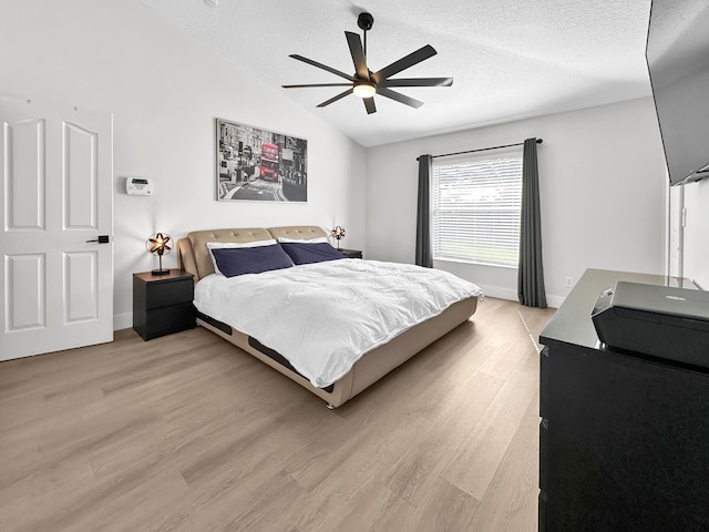 1726 SW Erie St, Port Saint Lucie, FL 34953 - bedroom featuring lofted ceiling, light wood-style flooring, a textured ceiling, baseboards, and ceiling fan