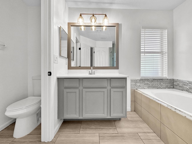 1726 SW Erie St, Port Saint Lucie, FL 34953 - bathroom featuring toilet, vanity, and tiled tub