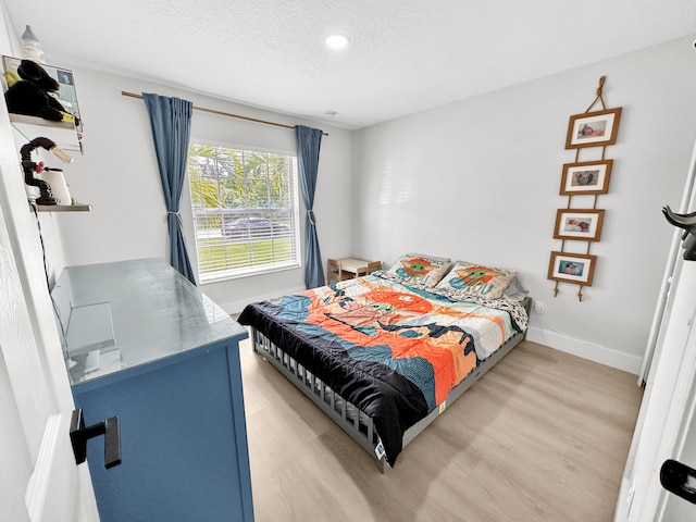 1726 SW Erie St, Port Saint Lucie, FL 34953 - bedroom featuring light wood-style flooring, a textured ceiling, baseboards, and recessed lighting