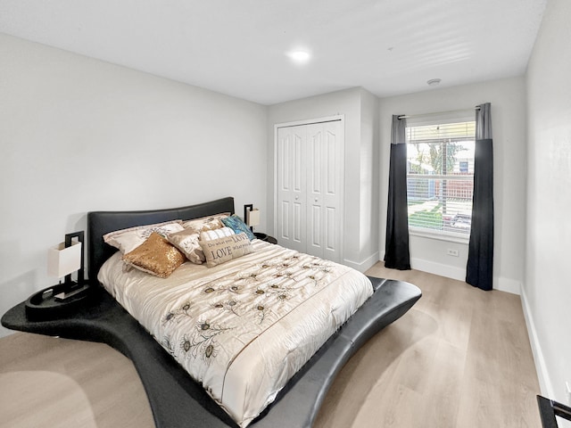 1726 SW Erie St, Port Saint Lucie, FL 34953 - bedroom featuring light wood-type flooring, a closet, and baseboards