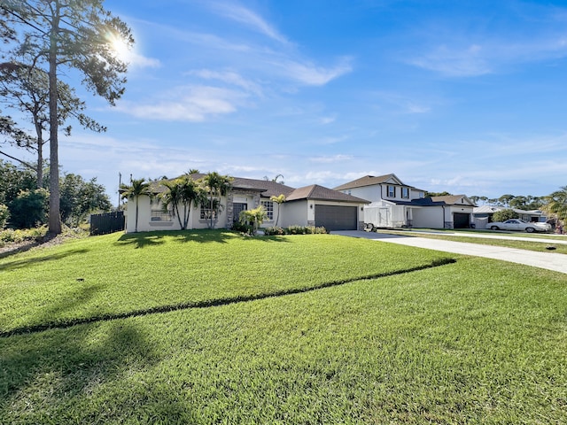 1726 SW Erie St, Port Saint Lucie, FL 34953 - view of front of home featuring concrete driveway, a garage, a front yard, and stucco siding